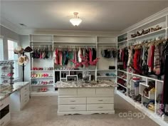 a walk in closet filled with lots of clothes