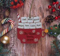 a christmas ornament with candy canes and other decorations on a wooden table