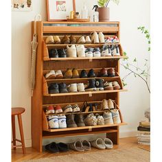 a wooden shoe rack filled with lots of shoes