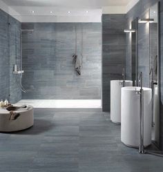 a modern bathroom with grey tile walls and floor