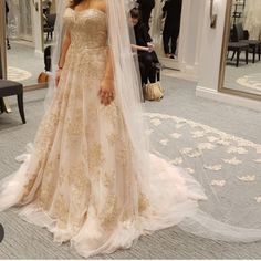 a woman in a wedding dress is posing for the camera