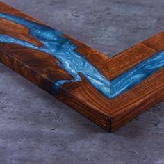 a wooden frame with blue paint on the edges and wood grain inlaying it