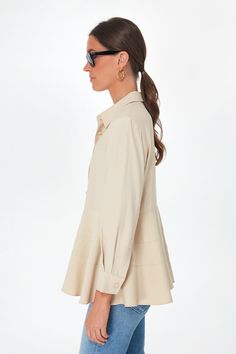 Your traditional button down with a twist, the Tan Ashlen Blouse is the easiest piece that you need to update any look. With covered buttons that add a dash of tailored class, this subtle fit-and-flare number is designed with a tiered hem that makes it stand out in an all-over creamy colorway that pairs well with everything. From denim to trousers, heels to sneakers, work to play, this year-round top does it all and will have you looking your best with just a few classic touches. Collar Long sle Spring Tailored Collared Shirt, Spring Business Casual Blouse With Spread Collar, Tailored Collared Shirt For Spring, Beige Button-up Shirt For Work, Beige Fitted Shirt For Work, Spring Fitted Single Breasted Shirt, Fitted Beige Shirt For Work, Spring Single-breasted Fitted Shirt, Fitted Single Breasted Shirt For Spring