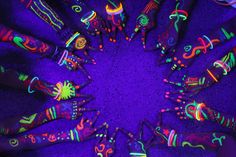 a group of hands painted with neon colors