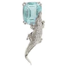 This 18 karat white gold Mesopotamian brooch is encrusted with a 3.1 carat neon copper bearing Paraiba tourmaline (10.8x8.2 mm). The gem is already quite large and catches the eye with its exquisite neon color and fine jewelry craftsmanship of tiny prongs. You can order this piece in white, rose, or yellow gold, with tanzanite, spinel, rhodolite garnet, emerald, tourmaline, or other gems. The brooch is designed by Berlin-based painter and jewelry designer, Polya Medvedeva. Paraiba Tourmaline, Rhodolite Garnet, Mesopotamia, Neon Color, Schmuck Design, 1 Carat, Tourmaline, Garnet, Emerald