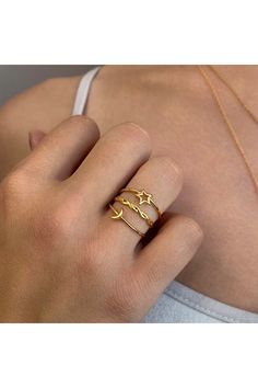 14K yellow gold vermeil star, moon, and twisted band ring set. Set of 3. Approx. 3mm individual band width. Imported Celestial Yellow Gold Stackable Jewelry, Gold Sterling Silver Stackable Initial Ring, Gold Sterling Silver Initial Stackable Ring, Symbolic Gold Midi Rings With Open Ring Design, Symbolic Gold Midi Rings With Open Shape, Symbolic Gold Open Midi Ring, Gold Symbolic Midi Rings For Anniversary, Gold Celestial Stackable Rings, Celestial Gold Rings In Sterling Silver