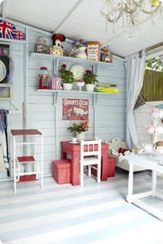 a room filled with lots of furniture and decor on top of white shelves next to a window