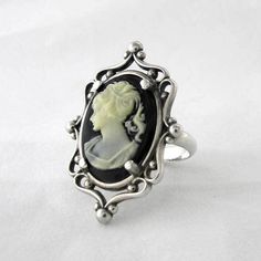 This ring features a 18 mm x 13 mm resin cameo set in a beautiful sterling silver frame ring and aged to resemble an antiqued heirloom. Due to the handmade nature of the creation, each piece may have slight variations. All items come with free resize and maintenance for the life of the product. Downloadable Ring Sizer Cameo Rings Vintage, Silver Gothic Cameo Jewelry, Art Deco Silver Cameo Jewelry, Antique Silver Cameo Rings, Vintage Black Cameo Ring, Black Cameo Jewelry For Collectors, Formal Silver Cameo Rings, Collectible Black Cameo Jewelry, Vintage Black Carved Rings