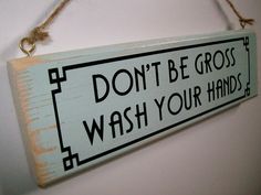 a sign hanging on the wall that says don't be gross wash your hands