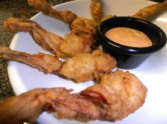 chicken wings and dipping sauce on a white plate