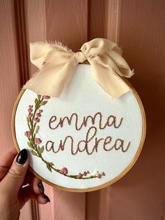 Looking for a fun, creative way to announce your baby's arrival? Or to gift someone special a unique, personalized item? Hand embroidered name hoops are a great way to add a personal touch to newborn photos or name/birth announcements that can double as nursery/room decor. They also make a nice gift for a sweet for a mama-to-be!  - The listing photo 'emma andrea' is a 6" stained wooden hoop on white fabric. Featured are hand stitched green stems and leaves with various shades of pink flowers. Th Hand Embroidered Name, Name Announcement, Baby Name Announcement, Birth Announcement Sign, Announcement Sign, Name Embroidery, Embroidered Name, Embroidered Gifts