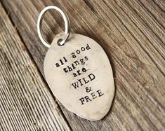 a metal keychain that says, all good things are wild and free on it