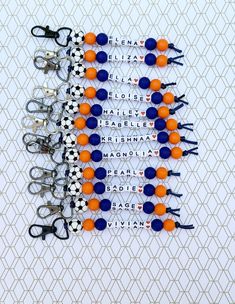 several pairs of scissors with orange and blue balls attached to each other on a white background