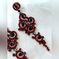 Red And Black Rhinestone Dangly Earrings. The Gemstones Remind Me Of Swarovski Crystals, Absolutely Gorgeous. Swirly And Spiral Like Patterned Shape. These Are Sure To Glam Up Any Look For A Special Occasion. Never Worn. Tags For Exposure: #Redandblack #Sparklyearrings #Rhinestoneearrings #Fancyearrings #Alternative Paisley Shape Gemstone Earrings Statement Piece Earrings Red And Black Alternative Goth Style Dark Style Vampy Style Vampire Costume Earrings Elegant Wedding Earrings Red Crystal Metal Earrings For Parties, Red Crystal Metal Party Earrings, Red Metal Crystal Party Earrings, Red Jeweled Earrings For Evening, Glamorous Red Metal Jewelry, Red Rhinestone Evening Earrings, Red Crystal Earrings With Rhinestones For Evening, Red Metal Chandelier Earrings For Party, Red Glamorous Chandelier Earrings For Party