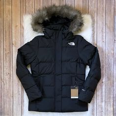 New With Tags- The North Face Women’s Gotham Water Resistant Jacket In Tnf Black With Fixed Adjustable Hood With Removable Faux-Fur Ruff, Front Zip Closure With Stormflap, Zippered Hand Pockets, Interior Zippered Pocket, Hem Cinch Cord, 550 Fill Goose Down Insulation And Heatseeker Eco Insulation. Standard Fit. The North Face Winter Outerwear With Detachable Hood, The North Face Winter Workwear Outerwear, Black Parka For Work, The North Face Black Puffer Jacket For Winter, Fitted The North Face Outerwear For Fall, Long North Face Jacket, North Face Metropolis Parka, North Face Arctic Parka, Grey Puffer Jacket