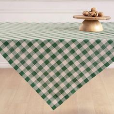 a green and white checkered tablecloth with walnuts on top