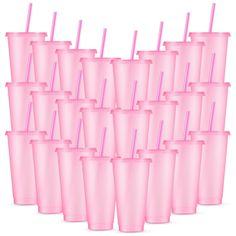 a bunch of pink cups with straws in them are lined up together on a white background