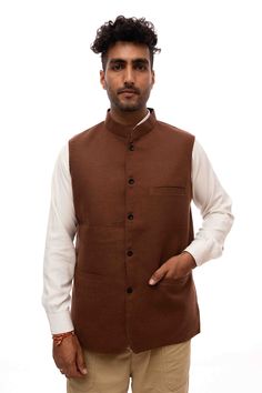 A brown woolen Nehru jacket is a fashionable and practical garment that combines the traditional Indian Nehru collar design with the warmth and comfort of woolen fabric. The Nehru jacket, inspired by Jawaharlal Nehru's signature style, features a stand-up collar that extends down the front without lapels, lending a unique and sophisticated look. Brown Stand Collar Blazer For Winter, Brown Winter Blazer With Stand Collar, Brown Winter Outerwear For Semi-formal Occasions, Brown Semi-formal Winter Outerwear, Semi-formal Brown Winter Outerwear, Tailored Nehru Jacket With Long Sleeves For Winter, Winter Nehru Jacket For Workwear With Long Sleeves, Tailored Long Sleeve Nehru Jacket For Winter, Long-sleeved Bandhgala For Fall Workwear