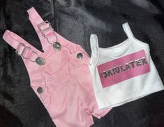 two pairs of pink and white shorts with straps on the bottom, one has a shirt that says sktullatter