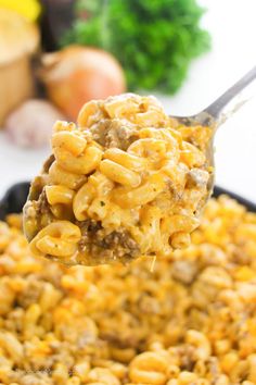 a spoon full of macaroni and cheese with meat