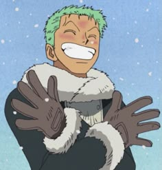 a man with green hair and gloves on his hands in front of snow covered ground