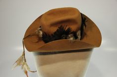 Virgin Wool Hat, Always on Top. Very fun feathers and turquoise stone. This is a sweet 1970s hat that is in good shape, there are some moth holes (never all the way through). How cool would that look on your man? Retro Short Brim Hat For Western-themed Events, Vintage Brown Mini Hat With Flat Brim, Vintage Rodeo Cap, Vintage Hat Bands For Kentucky Derby, Vintage Top Hat For Kentucky Derby Rodeo, Brimmed Hats With Feather Trim For Country Events, Vintage Fedora For Country Events, Vintage Flat Brim Top Hat For Country Events, Vintage Wide Brim Mini Hat For Country Events