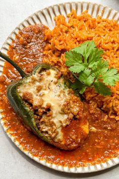 a white plate topped with rice and meat covered in sauce