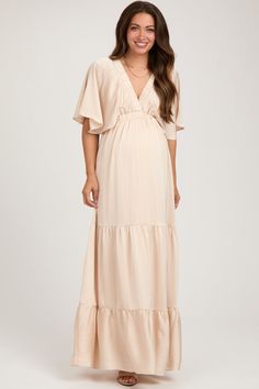 Beige V-Neck Flutter Sleeve Tiered Maternity Maxi Dress Chic Flowy V-neck Maternity Dress, Flowy V-neck Maternity Maxi Dress, Bohemian Maternity Maxi Dress With V-neck, Flowy V-neck Maxi Dress For Maternity, Bohemian V-neck Maxi Dress For Maternity, Maternity Dresses With Flutter Sleeves, Elegant V-neck Maxi Dress For Maternity Wear, Flowy Maxi-length Maternity Dress For Beach, Flowy Maternity Maxi Dress For Beach