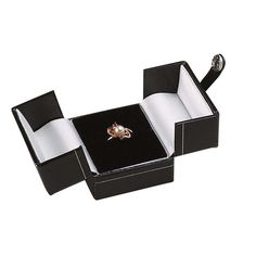 This faux-leather gift box opens at the center, creating an eye-catching presentation for a custom ring; this box is ideal for gift purchases. It features gold-color filigree borders and a secure, snap-tab closure. Add a decorative ribbon, wrapping paper or bow to customize the box. Black faux leather covers the cardboard box; velvet and satin line the interior. Each box is delivered in a two-piece packer. Hot stamp your gift box with your company name or logo, keeping you top-of-mind long after Formal Jewelry With Box Included For Gift, Formal Jewelry With Box For Gifting, Rectangular Jewelry Storage Gift Box, Elegant Keepsake Jewelry With Gift Box, Luxury Keepsake Rectangular Jewelry, Luxury Jewelry Storage Box For Gift, Luxury Jewelry Storage Box Gift, Gold Jewelry As A Gift In Original Box, Elegant Rectangular Keepsake Jewelry