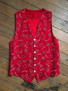 "Adorable novelty vest from the 1940s 50s. This one features little tomatoes that say \"Cute Tomata\" with faces on them!  Label: none Measurements: Pit to Pit: 16.5\" + Length: approx 24\" Condition: great vintage condition with a few missing stitches and minor wear (washed) *ALL SALES CONSIDERED FINAL -vintage is sold in \"as-is\" / \"as-found\" condition. we try to mention as best as possible any flaws noted but most of what we sell in this shop is workwear and worn in clothing that shows flaws and wear." Cheap Retro Sleeveless Vest, Fitted Red Retro Vest, Retro Red Sleeveless Vest, Red Retro Cotton Vest, Brown Leather Motorcycle Jacket, Vintage Sleeveless Vest With Button Closure, Vintage Floral Print Sleeveless Vest, Levis Denim Jacket, Levis Denim