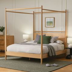 a bedroom with a four post bed and nightstands