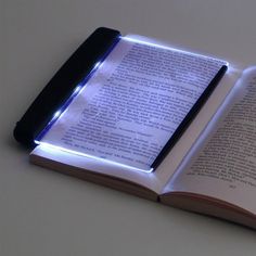 an open book with a light on it