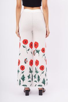 Elevate your wardrobe with the High Waist Knitted Trousers featuring a vibrant poppy pattern, designed to bring a touch of floral elegance to your everyday style. These trousers are crafted with a high waist and an elastic waistband, ensuring a comfortable and flattering fit for all-day wear.  The poppy pattern adds a playful and stylish element, making these trousers perfect for both casual outings and more formal occasions. Pair them with a blouse or a basic tee to create versatile looks that Floral Print Wide Leg Bottoms In Viscose, Spring Floral Print Viscose Bottoms, Knitted Trousers, Knit Trousers, Poppy Pattern, August Birthstone Jewelry, Gifts For New Mums, Soft Textiles, Pearl Jewellery Earrings