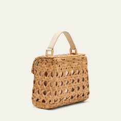 Cult Gaia "Sybil" crossbody bag in cutout rattan and leather  Flat top handle  Detachable crossbody strap Can be worn as a top handle or crossbody bag  Flap top with magnetic closure  Approx. 3.5"H x 7.9"W x 0.1"D Spot clean Imported Natural Bags With Bamboo Handle For On-the-go, Natural Color Bags With Bamboo Handle For On-the-go, Rectangular Natural Straw Bag With Detachable Strap, Natural Rectangular Straw Bag With Detachable Strap, Modern Natural Shoulder Bag With Bamboo Handle, Natural Woven Leather Top Handle Bag, On-the-go Crossbody Straw Bag With Detachable Strap, Natural Shoulder Bag With Detachable Strap For On-the-go, Natural Satchel Straw Bag For On-the-go