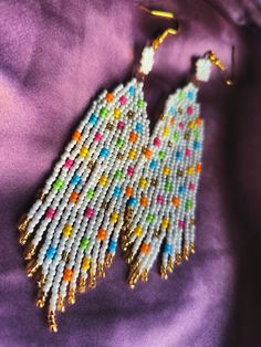 Design Drop Fringe Beaded Earrings with Colorful Confetti Dots.
They are elegant, fashionable and versatile, suitable for everyday wear, and for the holiday.
Developed a unique and inimitable design.
Made of high quality Japanese and Czech beads. (colors may vary due to your monitor settings).

Length - 10.5 centimeters
Width - 2.5 centimeters Multicolor Round Beads Earrings With Gold Beads, Colorful Dangling Beads Earrings For Party, Colorful Beaded Dangling Earrings For Party, Colorful Beaded Round Earrings, Multicolor Dangle Beaded Earrings With Gold Beads, Colorful Earrings With Dangling Round Beads, Colorful Large Beaded Earrings, White Beaded Earrings With Round Tiny Beads, Festival Earrings With Round Beaded Chain