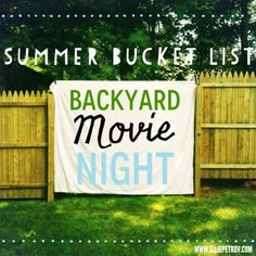 a backyard movie night banner in front of a fence