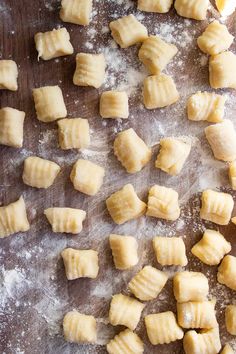 small pieces of dough sitting on top of a wooden table