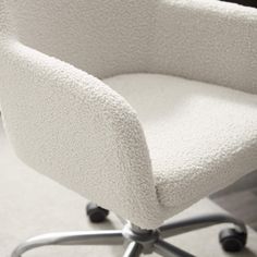 a white chair sitting on top of a hard wood floor