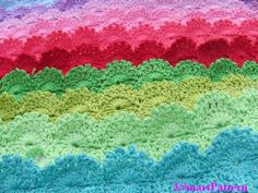 a crocheted blanket with multicolored waves on it's sides and the words, rainbow