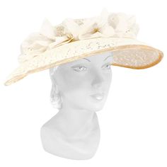 1950s cream-colored starched lace picture hat with handmade french silk flowers, velvet trim, and bow accent. This hat is meant to be worn with a hat pin to secure it to the head. Luxury Vintage Cream Hat, Cream Brimmed Cloche Hat For Evening, Vintage Cream Fascinator For Royal Ascot, Cream Vintage Fascinator For Royal Ascot, Cream Brimmed Evening Costume Hats And Headpieces, Cream Brimmed Evening Costume Headpieces, Cream Mini Hats For Vintage Events, Cream Brimmed Evening Costume Hat, Cream Brimmed Costume Hats For Evening