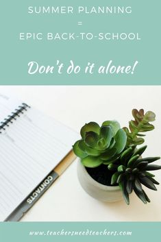 a small potted plant sitting on top of a table next to a notepad