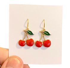 Cherry Earrings, Funny Earrings, Red Cherry Earrings, Miniature Fruit Earrings, Food Earrings, Weird Earrings, Funny Gift For Women Gorgeous Cherry Earrings that will look great with a lovely dress or jeans and t shirt. Handmade gold plated ear wires with gorgeous red enamelled Cherry charms and green enamelled leaves on gold plating. Perfect earrings for gifts or as a treat for yourself. 🍄 SIZE :approximately 3.5 cm drop. 🍄 MATERIALS: resin, gold plated wire, green and red enamel.  🍄 DESPATCH TIME: Posted next working day. 🍄Your Bonnie Wishes Jewellery will come wrapped in tissue paper with a lovely sticker and will be posted in a strong postal box to ensure your order reaches you in perfect condition. 🍄 I source premium quality jewellery findings worldwide, I use lead and nickel fre Trendy Enamel Nickel-free Earrings, Trendy Nickel-free Enamel Earrings, Retro Drop Earrings Jewelry Gift, Trendy Round Plug Earrings As Gift, Trendy Round Plug Earrings For Gifts, Cherry Colored Earrings Gift, Cherry Colored Round Earrings For Gift, Cherry Round Earrings For Gift, Retro Dangle Earrings Gift