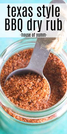 a glass jar filled with bbq dry rub on top of a blue tablecloth