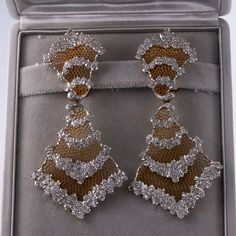 Pair of exquisite Honeycomb chandelier earrings by Buccellati, in 18k gold, with approx. 4 carats in VS/Si/H diamonds. Come with Buccellati box. DESIGNER: Buccellati MATERIAL: 18k Gold GEMSTONES: Diamond DIMENSIONS: Earrings are 3 3/8" x 1.5". WEIGHT: 43.4 grams MARKED/TESTED: Italy, 18k, 750, Buccellati. CONDITION: Previously Owned/ Excellent Condition Luxury Diamond Bridal Earrings With Pave Setting, Luxury Diamond Chandelier Earrings, Luxury Diamond Chandelier Earrings With Diamond Cut, Formal Yellow Gold Diamond Chandelier Earrings, Luxury Chandelier Earrings For Formal Occasions, Luxury Diamond Chandelier Earrings With Diamond Accents, Luxury Diamond Chandelier Earrings With Accents, Luxury Diamond Cluster Earrings, Luxury Cubic Zirconia Chandelier Earrings