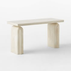 a white marble bench sitting on top of a table