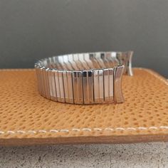 NOS unused 1960s old-stock Admiral stainless steel scissor-expansion watch bracelet.   The ends are curved 11/16" (17.2mm).   Spring bars are included.  The length at the spring bars is 5 1/2" (140mm).    (1) 3/8" removable link.   6B.9997 Vintage Silver Watch Band With Stainless Steel Clasp, Vintage Silver Stainless Steel Watch Accessories, Vintage Adjustable Silver Watch Bands, Vintage Adjustable Metal Watch Accessories, Vintage Silver Adjustable Watch Bands, Retro Round Silver Watch Accessories, Watch Bracelet, Vintage Watches, Watch Band