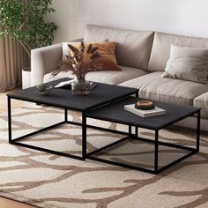 two coffee tables sitting on top of a rug in a living room next to a couch