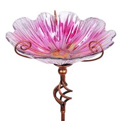 a pink glass flower on a metal stand