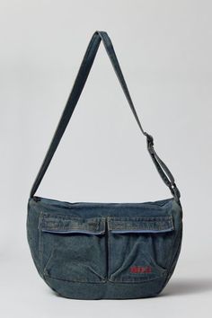 Acid wash crossbody bag by UO's own BDG label. Durable cotton canvas bag with zippered pockets and an adjustable webbing shoulder strap. Urban Outfitters exclusive. Features Crossbody bag from BDG Acid wash cotton canvas Utility style pockets Adjustable webbing strap UO exclusive Content + Care 100% Cotton Spot clean Imported | BDG Acid Wash Crossbody Bag in Blue, Men's at Urban Outfitters Y2k Bags Men, Quick Sewing Gifts, Y2k Bags, Purse Outfit, Denim Bags, Luxury Bags Collection, Aesthetic Bags, Top Clothes, Man Purse