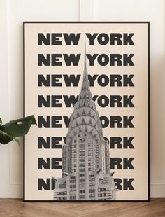 a black and white poster with the words new york on it in front of a plant